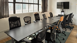 A conference room table set up for a group meeting
